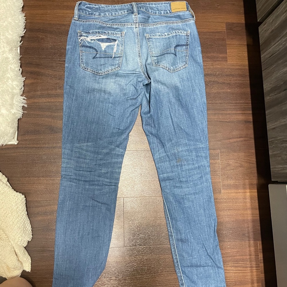 Boyfriend pair of denim jeans with holes.